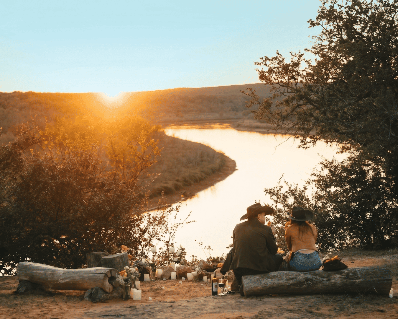 Couple enjoying sunset by river at Wild Atter Ranch.
