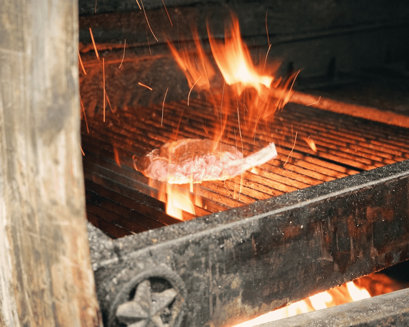 Blacksmith forging metal on an open flame for traditional craftsmanship.