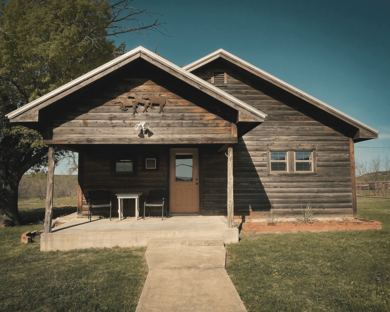 Charming rustic cabin with wooden exterior and porch at Wild Atter Ranch.