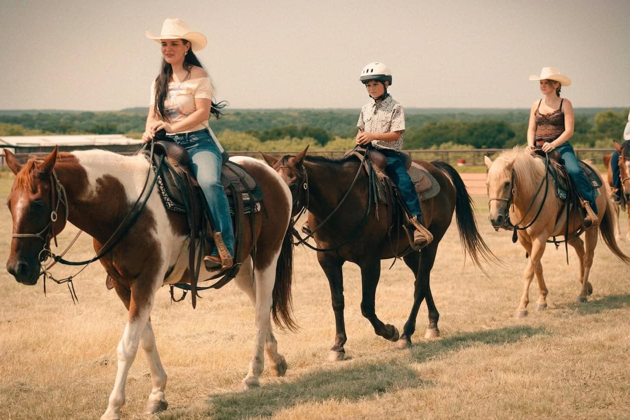 People horseback riding at Wildcatter Ranch in Texas.