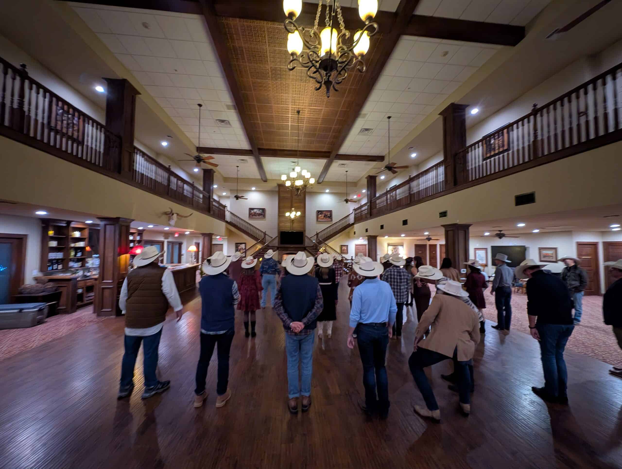 Group of people touring the spacious interior of Wildcatter Ranch.